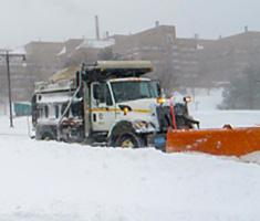 City Plow Truck During Snow Storm Plowing Belmont Street
