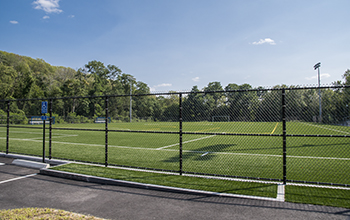 Artificial Turf Structure at Glodis Field Seen Through a Fence