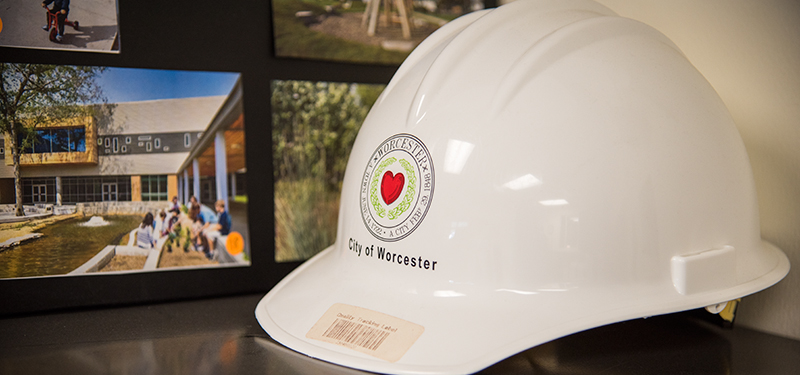 White Hard Hat on Shelf With the City of Worcester Seal Imprinted on the Front