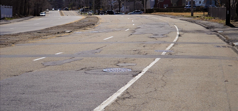 Mill Street Road Conditions with Cracked Pavement and Patches
