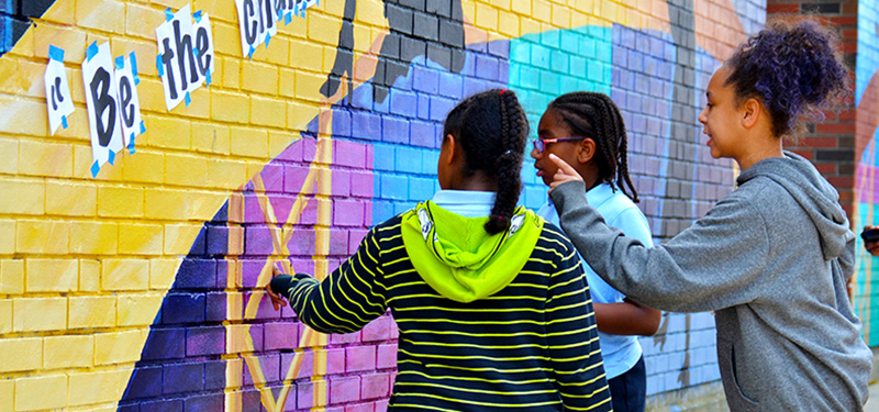 Three Female Youths Looking at Painted Mural