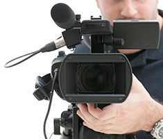 Camera Operator Standing Behind Video Camera