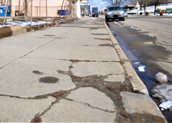 City Sidwalk and Curb with Cracks and Broken Areas