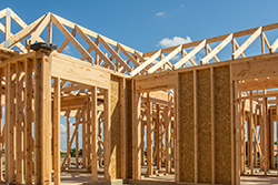 Wood Framing and Structure of Housing Unit Being Built with Blue Sky Behind