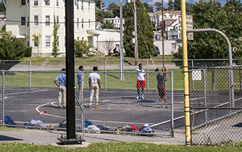 Group of People Playing at the Enclosed Basketball Court at Kendrick Field