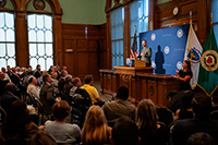 City Manager Speaking at Podium to a Seated Audience with ASL Interpreter on the Right