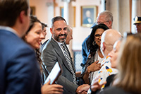 City Manager in Crowd of Attendees Shaking Hands with a Guest