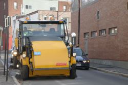 Street Sweeper Going Down the Side of a Road