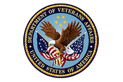 US Department of Veterans' Affairs Logo, Black and Yellow Circle with Eagle Holding 2 American Flags and 5 Yellow Stars