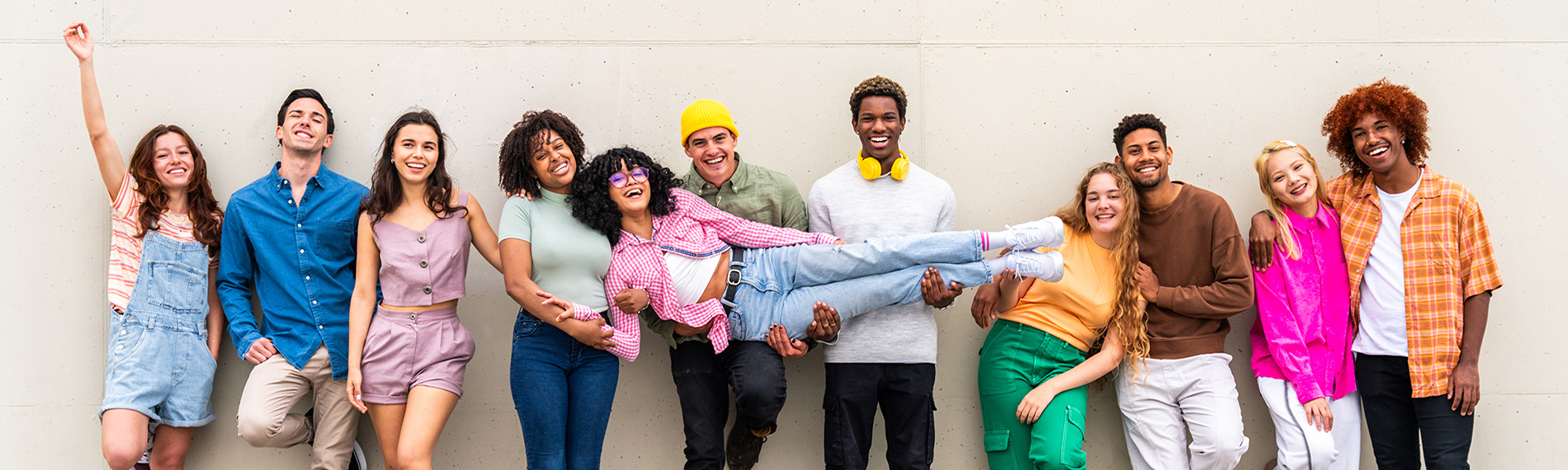 Group of Young People Standing Against a Wall