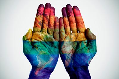 Two Rainbow Colored Hands with the World Painted on Them