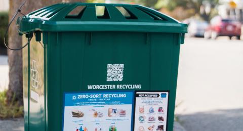 Green Recycling Container with Lid on Sidewalk of a City Street