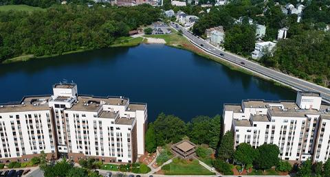 Aerial Photo of High-Rise Complex in Front of Body of Water and Roadway in Worcester
