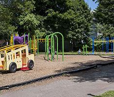 Banis Street Playlot Sign with Playground in Background