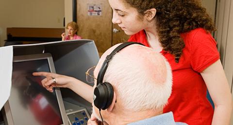 Poll Worker Assisting a Voter